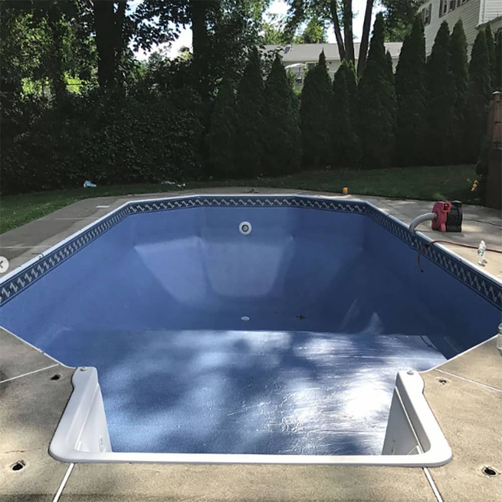 professional team at work in michigan replacing pool vinyl liner