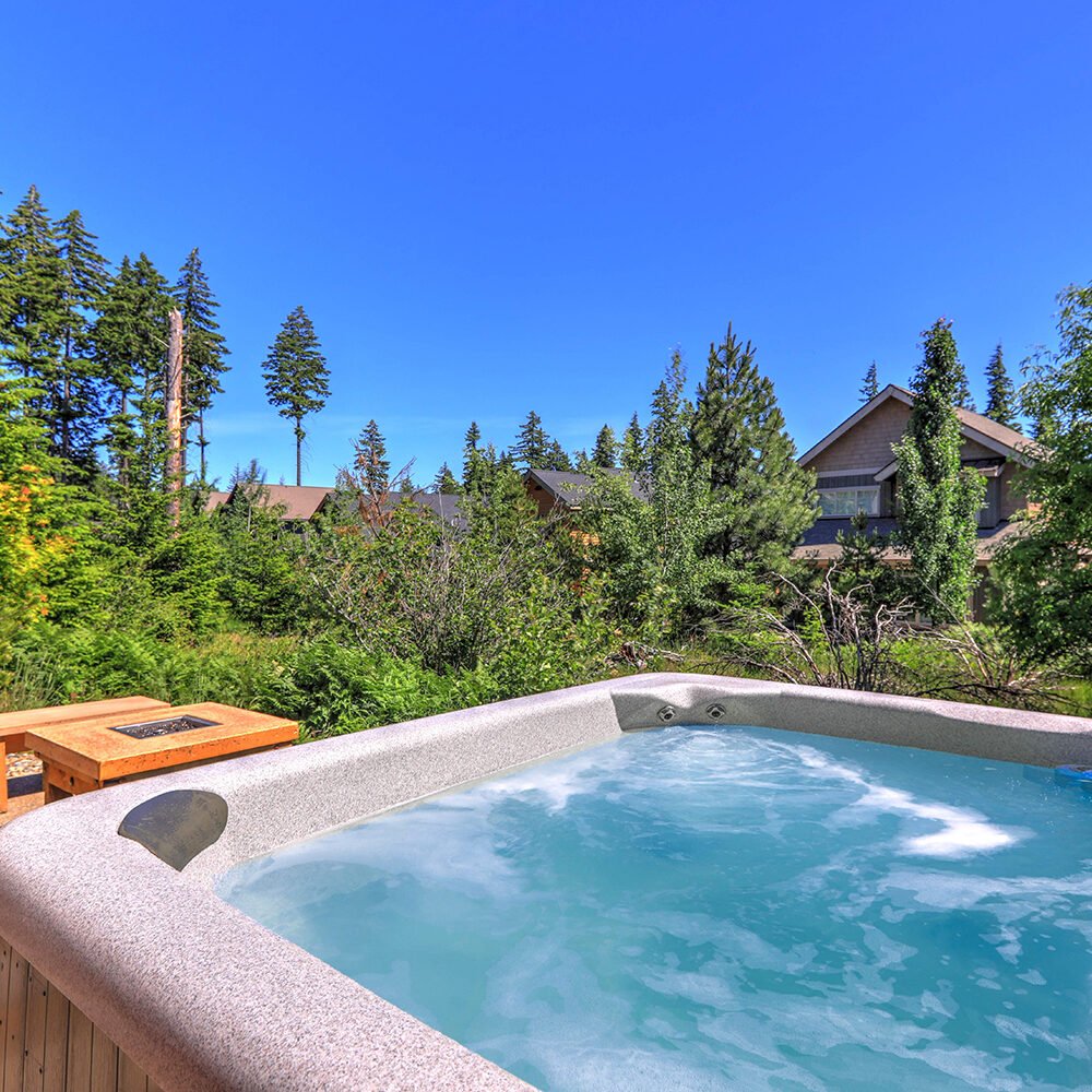 Luxurious hot tub installation by Bontrager Pools in a serene backyard setting